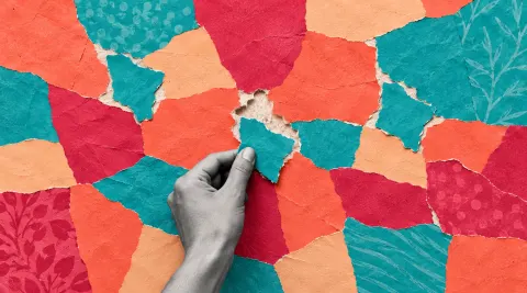 A monochrome cut-photo hand places a turquoise repair onto a torn coral, raspberry, and apricot paper quilt, with similar repairs nearby.